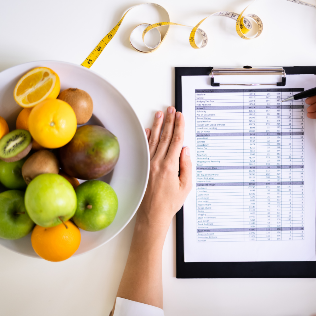 "Fresh fruits, a measuring tape, and a personalized nutrition plan on a clipboard, representing healthy eating, weight management, and fitness coaching."